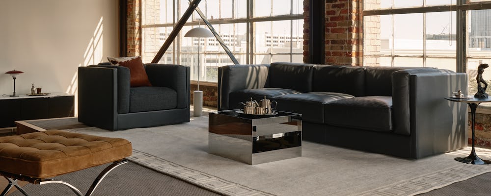 Symme three-seat sofa in Obsidian leather, Symme Armchair and D'Urso Coffee Table
